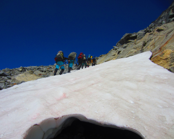 Team hiking up a glacier